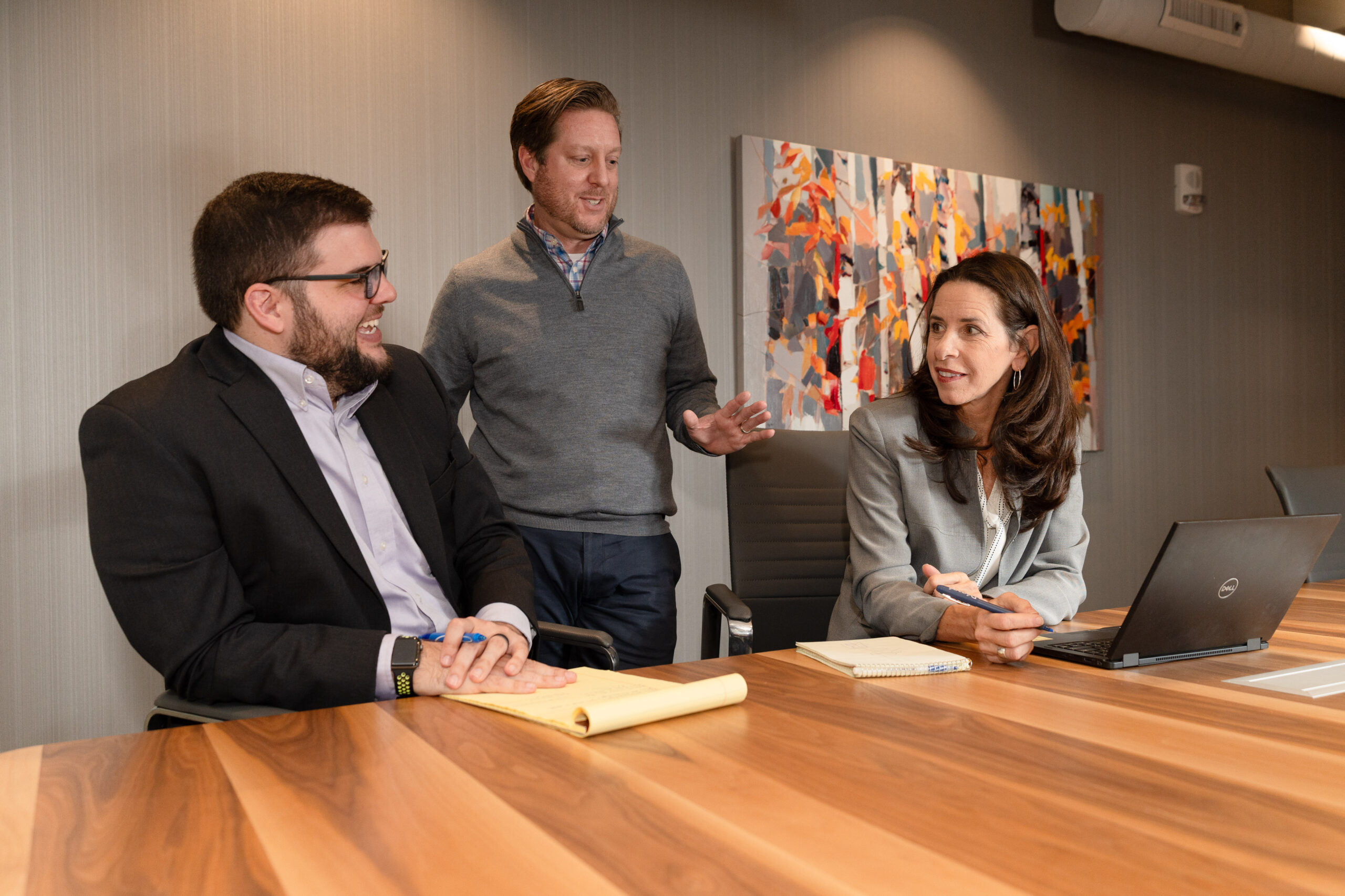 Attorney Jeremy Orenstein working in on a case in the Hilger Hammond offices with attorneys Ben Hammond and Aileen Leipprandt.