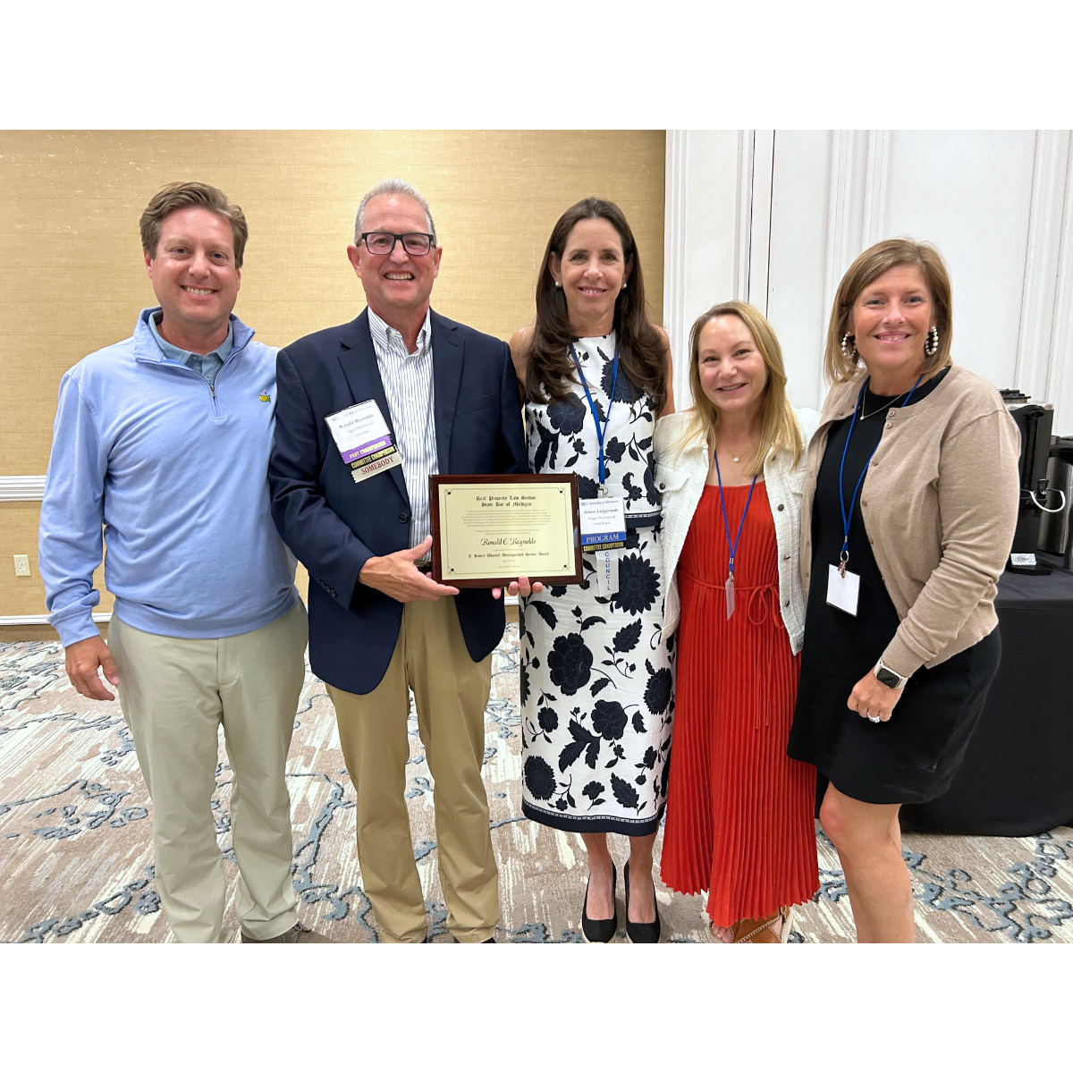 Hilger Hammond Attorneys Ben Hammond, Ron Reynolds, Aileen Leipprandt, Jill Miller, and Stacey Knowles pose together at the State Bar of Michigan's Reap Property Law Section (RPLS) 2024 summer conference where attorney Ron Reynolds won a prestigious award recognizing his many years of service in Michigan property and eminent domain law.